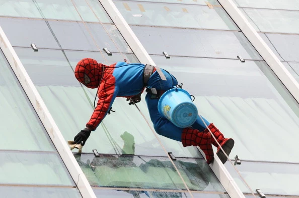 Indonesian Window Cleaner At Work In Spider-Man Uniform